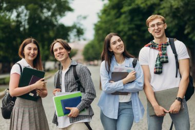 Portrait of a group of happy students on the street. The concept of college education