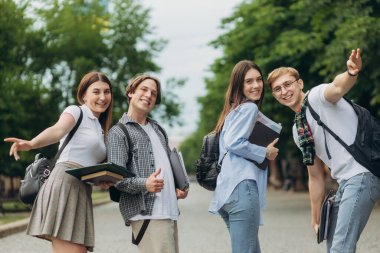 Portrait of a group of happy students on the street. The concept of college education