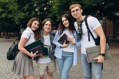 Portrait of a group of happy students on the street. The concept of college education