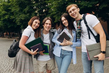 Portrait of a group of happy students on the street. The concept of college education