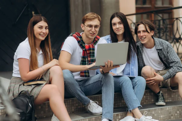 Happy young students are chatting in campus