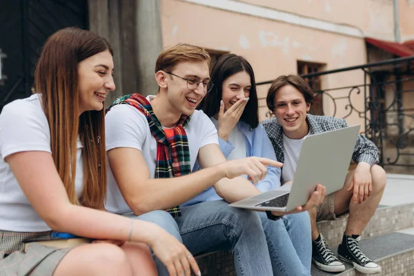 Happy young students are chatting in campus