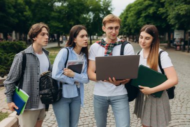 Young people looking at laptop together