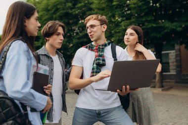 Young people looking at laptop together