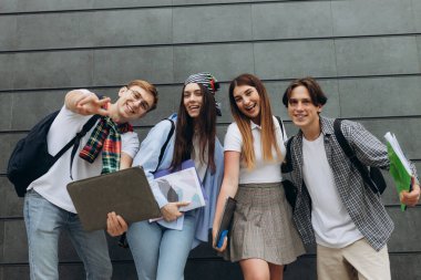 Smiling group of students holding notebook books and study notebooks. Happy friends. Learning concept. Copy space