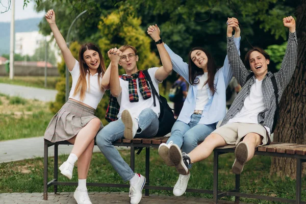 Happy Multiethnic Friends Sitting Park Showing Rejoice Gesture — Stock Photo, Image