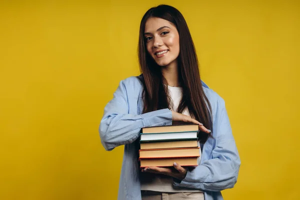 Portrait Smiling Pretty Girl Holding Books Looking Camera Isolated Yellow — Foto de Stock