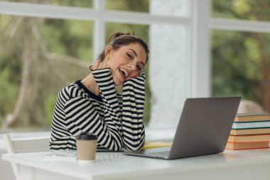 happy smiling girl doing work using laptop at home