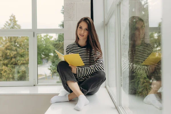 Portrait Attractive Girl Sitting Windowsill Doing Homework Notebook — Foto de Stock