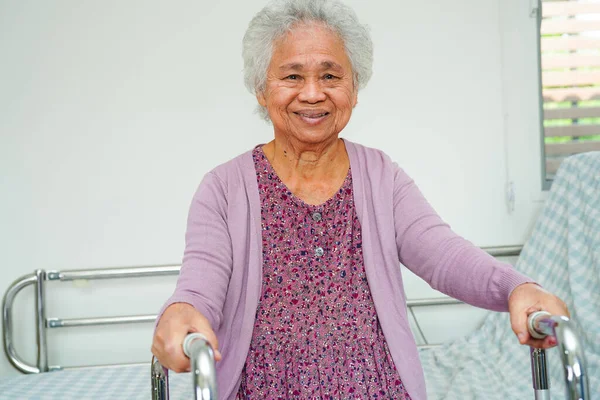 亚洲老年妇女病人坐在医院里 面带微笑 快乐地躺在床上 — 图库照片