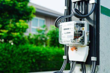 Electric measuring power meter for energy cost at home and office, solar cell concept.