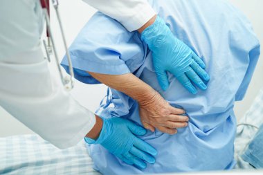 Doctor examine and treat asian elderly patient muscle back pain problem and physical therapy in hospital.