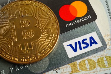 Bangkok, Thailand - December 15, 2021 Golden bitcoin with credit card on US dollar banknotes money for business and commercial, Digital currency, Virtual cryptocurrency.