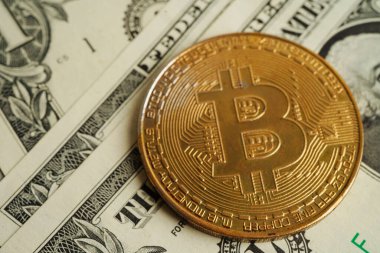 Golden bitcoin on US dollar banknotes money for business and commercial, Digital currency, Virtual cryptocurrency, blockchain technology.
