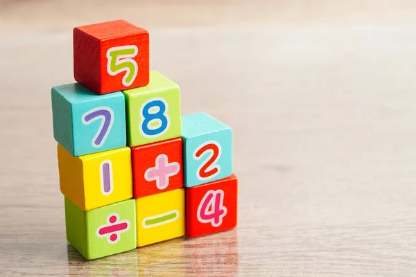 Number wood block cubes for learning Mathematic, education math concept.