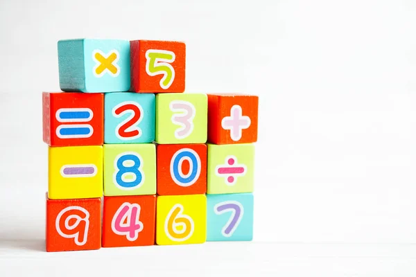 Number wood block cubes for learning Mathematic, education math concept.