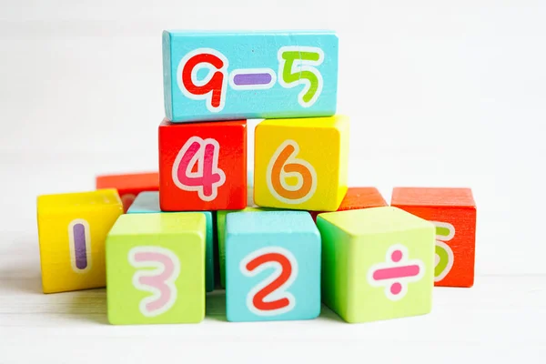 Number wood block cubes for learning Mathematic, education math concept.