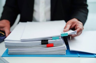 Business woman busy working with documents in office.