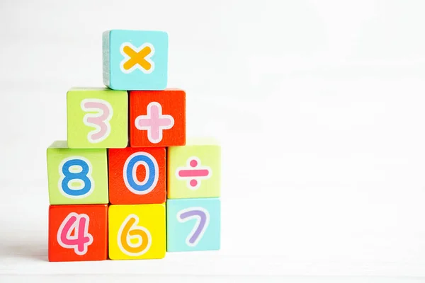 Number wood block cubes for learning Mathematic, education math concept.