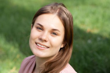 Portrait of a girl in pink on a green lawn. Austria, Salzburg. High quality photo
