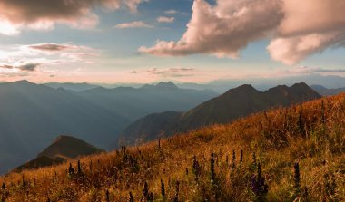 Autumn red slopes of the Alpine mountains under the setting sunlight. Gasteinertal, Austria. High quality photo