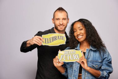 Kadın erkek fotoğraf kabini aksesuarlarıyla poz veriyor