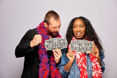 Kadın erkek fotoğraf kabini aksesuarlarıyla poz veriyor