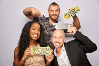 Kadın erkek fotoğraf kabini aksesuarlarıyla poz veriyor