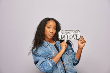 Kadın fotoğraf kulübesinde poz veriyor.