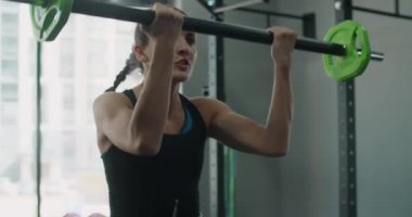 Steadicam shot: atlet kadın halterle ağır çekimde zıplıyor, kadın spor salonunda ağırlık ile kardiyo yapıyor, 4k 120fps Prores HQ