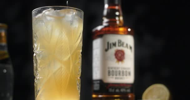 WARSCHAU, POLEN - 10. SEPTEMBER 2021: Cocktail mit Jim Beam und Eis wird in highball, 4k 120fps Prores HQ mit einem Barmenlöffel gemixt — Stockvideo