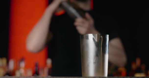 Profesionální barman míchá ingredience pro koktejl v třepačce ve zpomaleném filmu, barman pracuje u pultu, 4k 120 fps Prores HQ — Stock video
