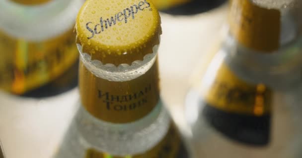 WARSAW, POLAND - SEPTEMBER 10, 2021: tilting shot of the schweppes tonic bottle from logo to the cap, schweppes tonic product advertising, 4k Prores HQ 60fps — Stock Video