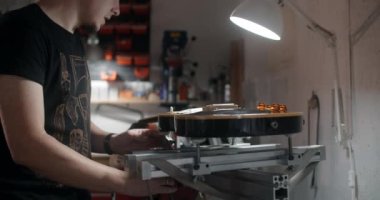 Gitar teknisyeni elektro gitarı müzik aletleri tamirhanesinde takıyor. 4k 60p 10 bit.