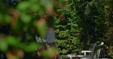 Genç dansçılar, kadın esneme egzersizi yapıyor ve bacaklarını parktaki banka dayıyorlar. Yaşam tarzı spor videoları açık havada, 4k 60 fps Prores Merkezi