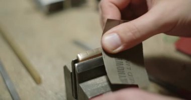 Gitarcı Sanatçı Sands gitarı zımpara kağıdıyla parçalıyor. Atölyede müzik aletleri ve parçalar yapmak, 4k 60 peni Prores