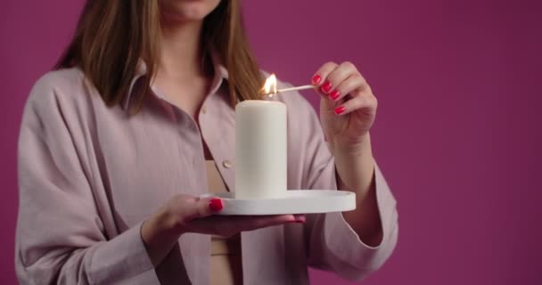 Woman in pajamas lights the big candle with match in slow motion, 4k Prores HQ — Stock videók
