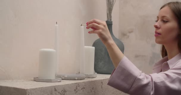 Woman in pajamas lights the candles with match in slow motion at her bedroom, 4k Prores HQ — 图库视频影像