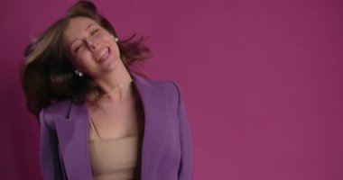 Happy woman dances while listening music in bluetooth headphones, 4k Prores HQ 60fps