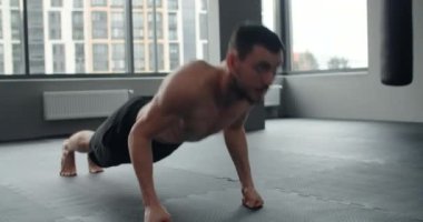 Athlete performs push-ups on his fists at the gym, workout training, 4k 60p Prores HQ