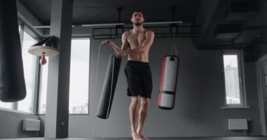 Athlete is skipping with jumping rope at the gym in slow motion, crossfit and cardio exercises, 4k 60p Prores HQ