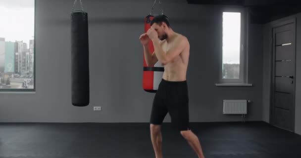 Fighter is training knee blow and kicks in slow motion at the fight club, fighting with shadow, mixed martial arts, 4k 60p Prores — Stockvideo