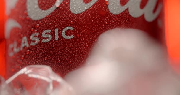 WARSAW, POLAND - SEPTEMBER 12, 2021: product video of the spinning can of Coca-Cola classic in the ice and water drops on the red background, 4k Prores HQ — Stok Video