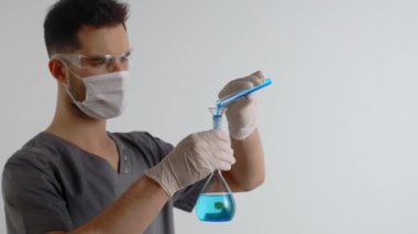 Laboratory medic pours chemical substance from test tube to the flask. Medications and vaccine development
