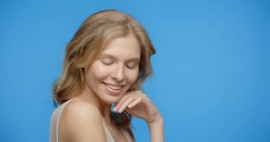 Blonde pretty woman poses in the beauty video on the blue screen. Womens cosmetics usage. Beauty care procedures on blue screen, 4k Prores HQ