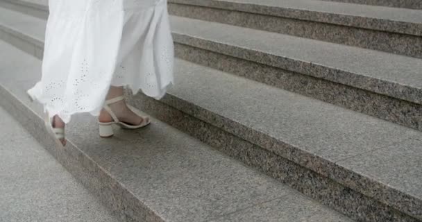 FOLLOWING CAMERA: the legs of dancer woman in white dress walking the stairs up outdoors in slow motion, 4k 120 fps Prores HQ — Video Stock