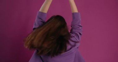 Happy woman dances while listening music in bluetooth headphones, 4k Prores HQ 60fps