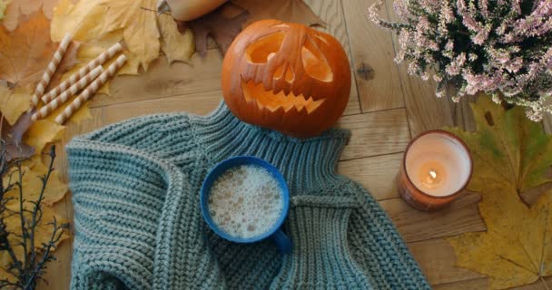 Asztali videó díszített őszi halloween összetétele meleg légkörben sütőtök fej, gofri, levelek és fekete forró tea, 4k 60p — Stock videók