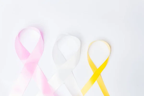 pink ribbon fight against breast cancer, white ribbon, fight against violence against women, yellow ribbon, fight against suicide prevention, isolated on white background.