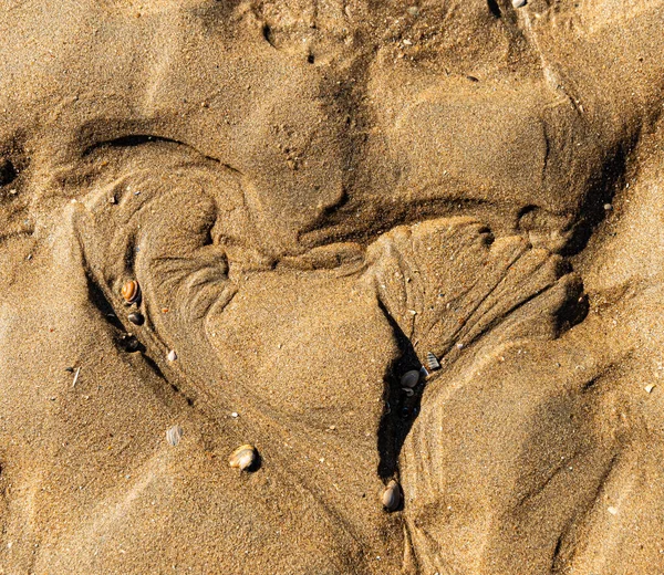 kalp şekli kumsalda kumda yontulmuş.